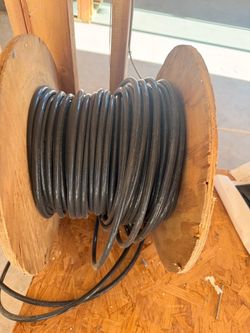 Black Electrical Wire on Wooden Spool