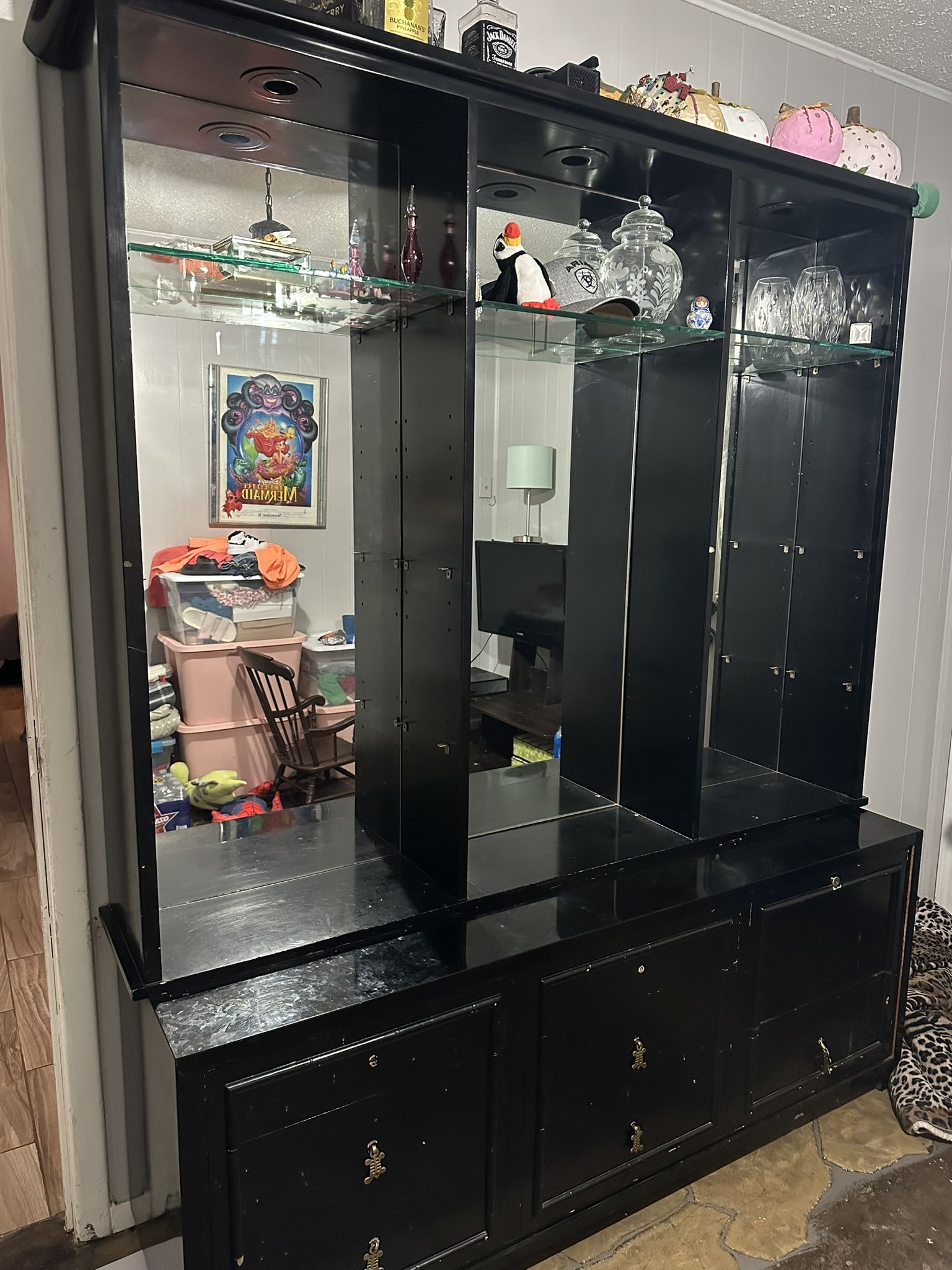 Black Cabinetry With Mirror And Glass Shelves