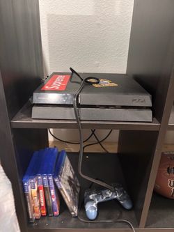 PS4 with controller and games