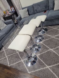 Bar stools white set of 4 with foot rest adjustable height in good condition no rips /with clear back /taking Offers