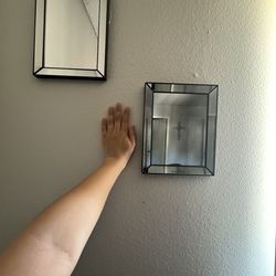 Two picture framed mirrors