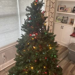 6’ artificial Christmas tree with multicolored lights
