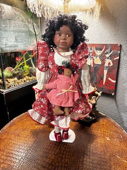 Vintage African American Porcelain Doll with Miniature Ragdoll