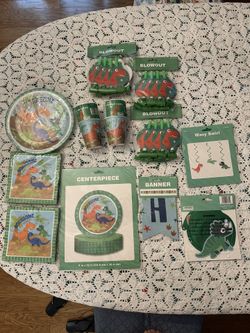 Kids Dinosaur Party Package.  14 Plates, 40 Napkins, 20 Cups, 24 Blowout Horns, 1 Happy Birthday Banner, 6 Dinosaur Decorations, 1 Table Decoration