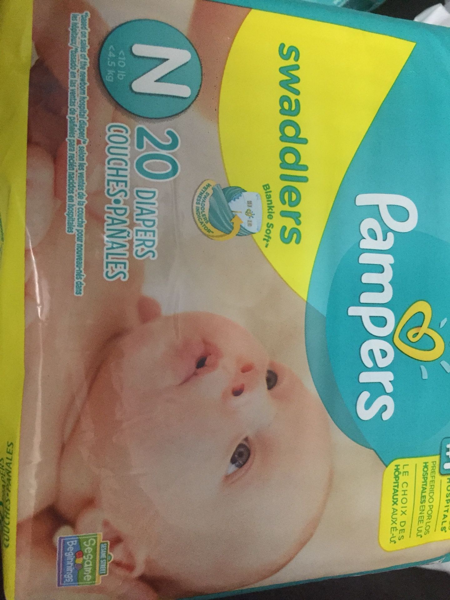 3 unopened bag of size newborn diapers; 1 Huggies and 2 pumpers