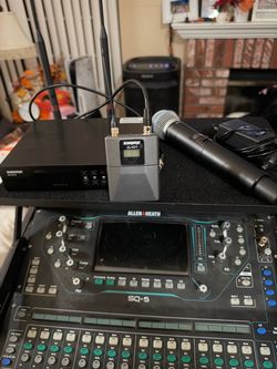 Shure QLX-D system that includes both a handheld microphone and a bodypack transmitter