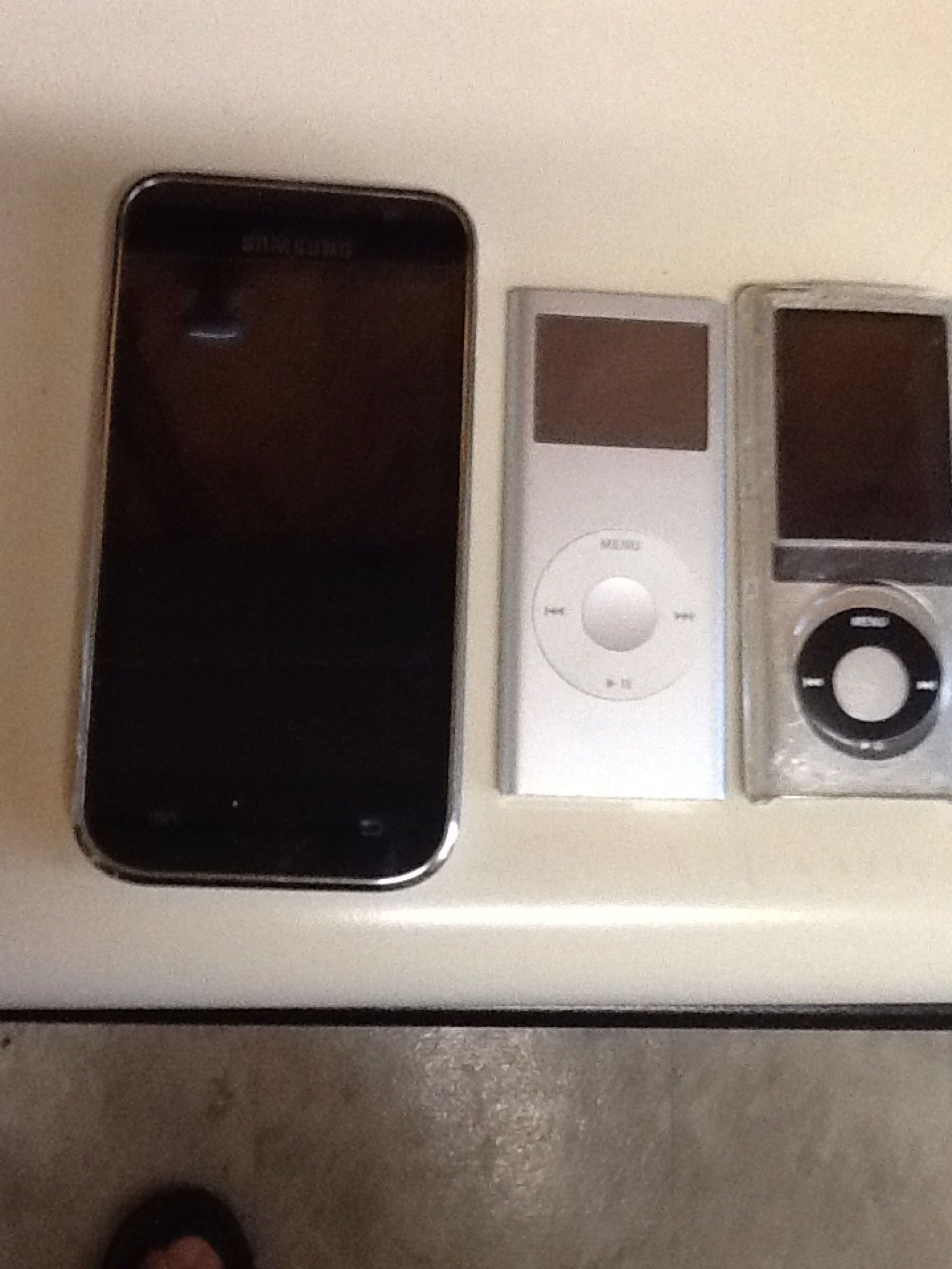 Two Apple IPod's and one Samsung MP3 Player today special one with camera