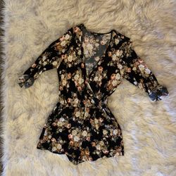 3/4 Sleeve Romper.  Black Floral , Light Weight .  Button Front For More Modest Look.  Or Leave Undone For More Relaxed Look.  Dress Up With Heels