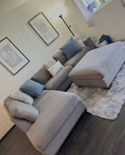 Beautiful grey Costco sectional couch with ottoman