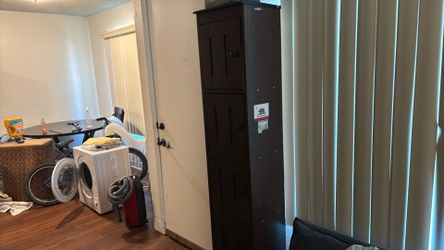 Tall wooden cabinet with 5 separate shelves with cabinet doors