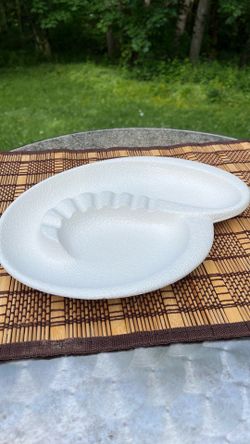 This is a vintage Royal Haeger MCM white textured pottery ashtray, model #153, with a boomerang or biomorphic shape
