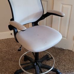 Office Chair with wheels and footrest.