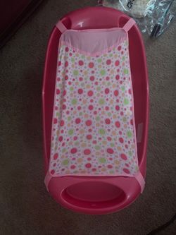 Pink baby bath tub with new born sling