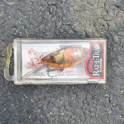 This is a vintage Bill Lewis Rat-L-Trap Floater fishing lure in an orange color scheme.