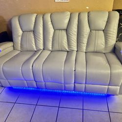 Like New Leather Electric Dual Reclining Couch With Electric Headrests And Dual USB And Led Lighting 