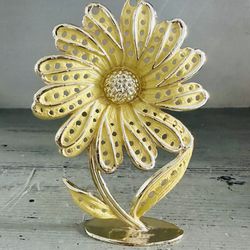 Vintage Daisy earring holder. Gold tone metal with yellow daisy.  Nice condition. 5” tall x 3 1/2” wide 