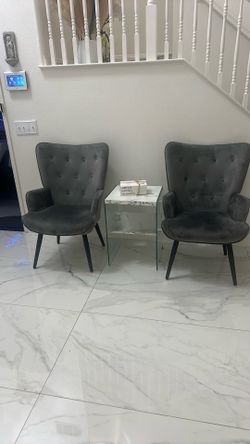 Two Chairs And Coffee Table With A Small Table