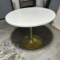 white table with gold stand 