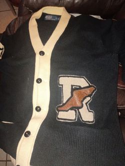 This is a Polo Ralph Lauren P-Wing varsity letterman cardigan made from a linen and cotton blend. 