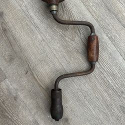antique brace and bit hand drill. It's a manual drilling tool, often used for woodworking 