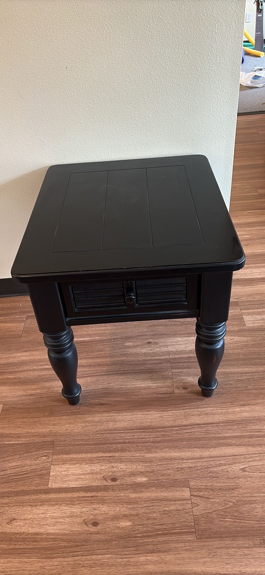 Black wooden end table with drawer