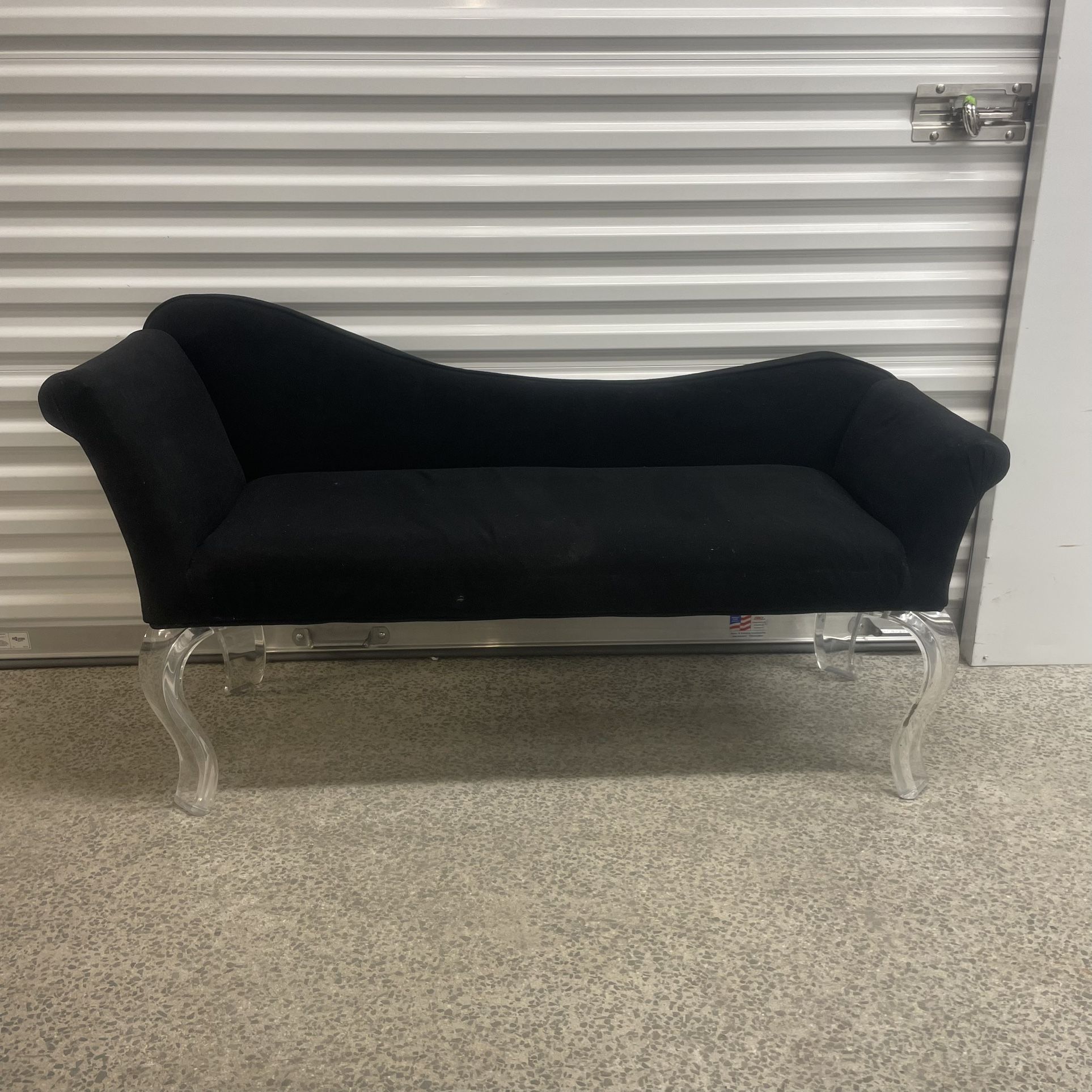 Reclining bench with acrylic legs located near the Miami Design District