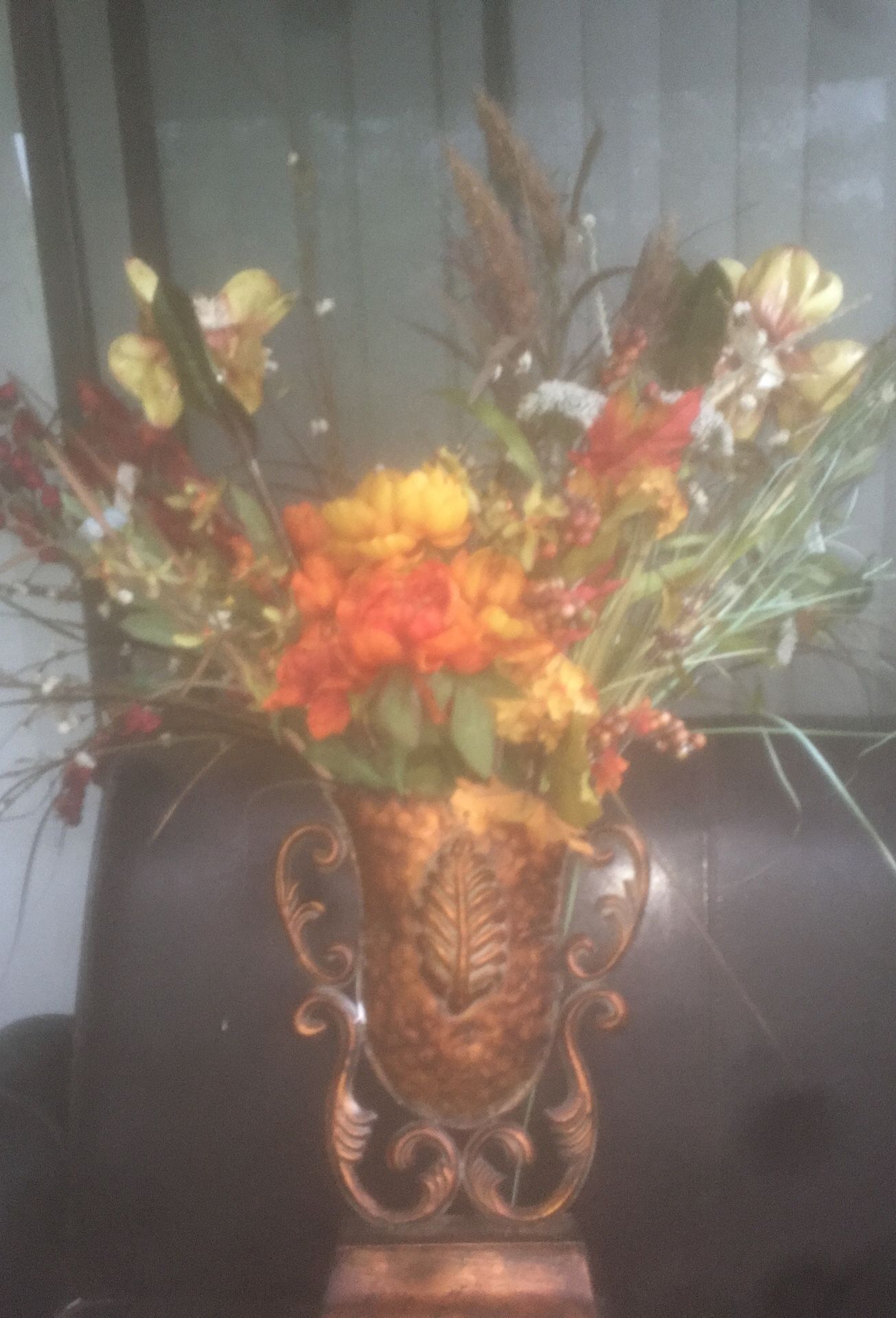 Flower arrangement in copper vase