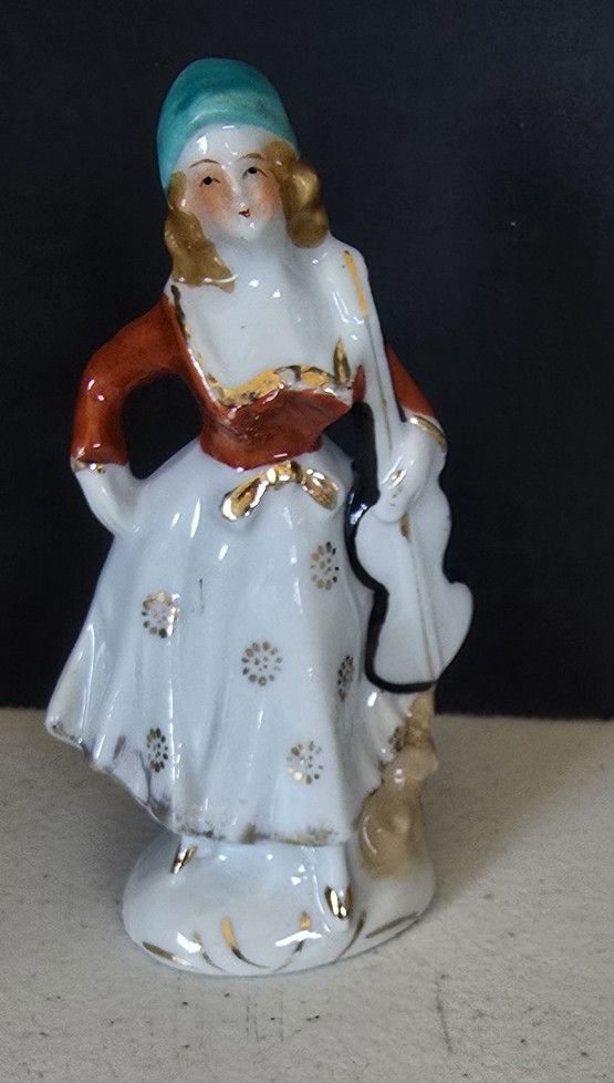 VTG Porcelain figurine lady in blue bonnet holding violin / chelo