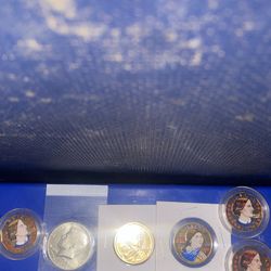 Three colorized Susan B Anthony one colorized one dollar and one proof Silver Me