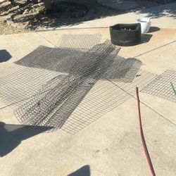 Pieces Of Meshed Fencing Metal, Some Covered With Plastic
