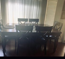 Solid wood expandable dining table with 6 chairs.