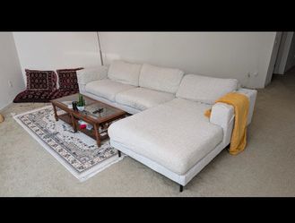 Comfortable off white sectional couch with ottoman from living Spaces