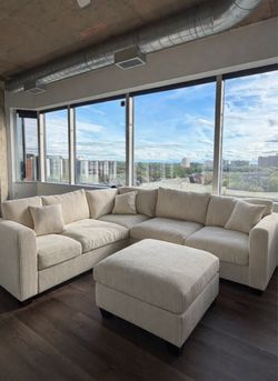 Brand new ivory color corduroy Sectional Sofa with ottoman and 2 accent pillows.