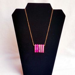 Handmade necklace with pink mother of pearl bars, golden colored bars and golden square beads on a golden colored chain