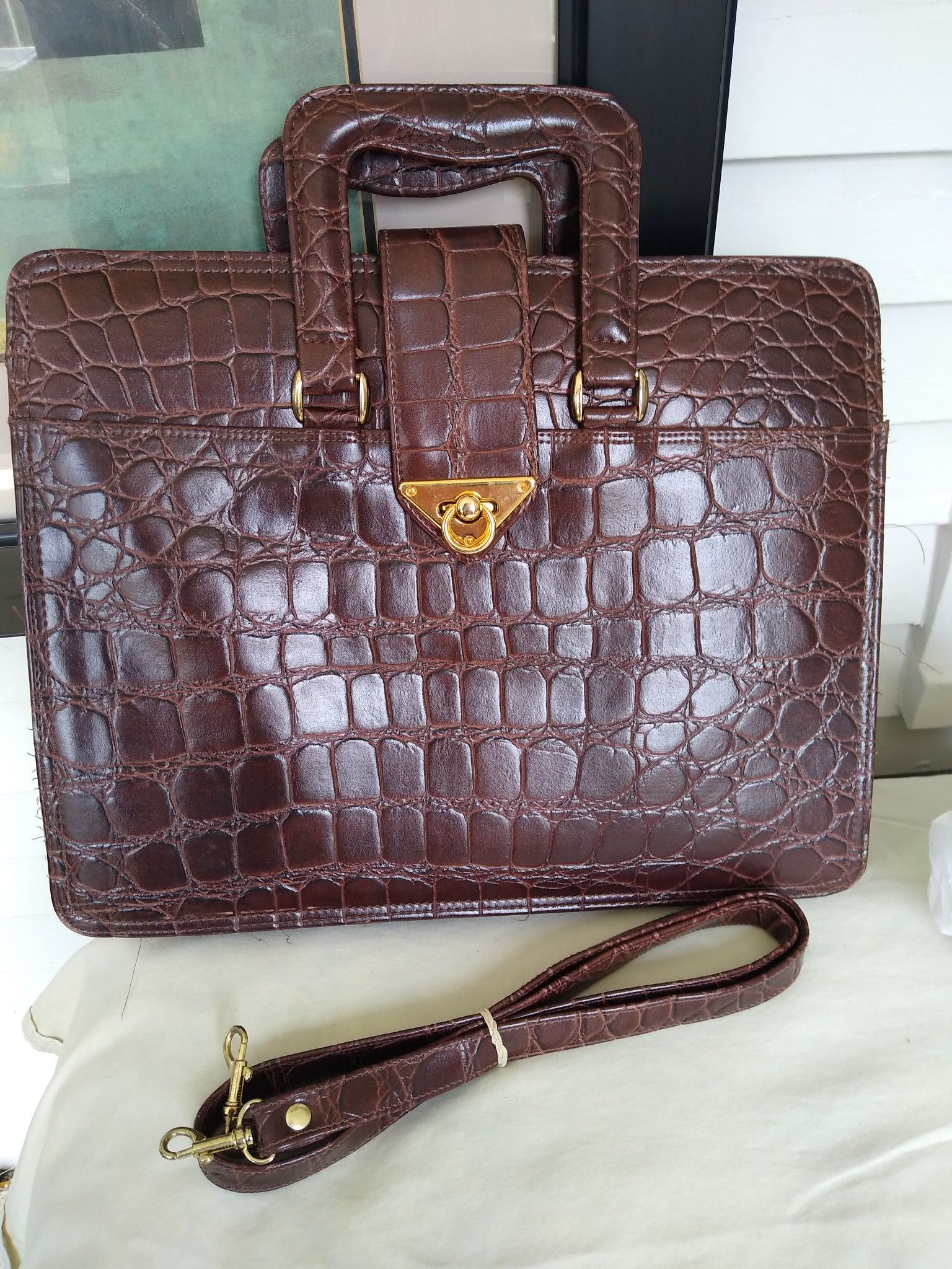 Dark brown alligator pattern attache case.