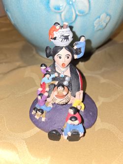 Pueblo-style Storyteller Figurine Central female figure surrounded by children.