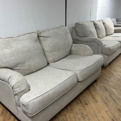 Delivery available beige sofa/couch + loveseat with pull out bed