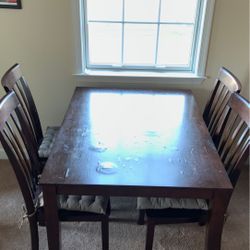 Wooden dining table with 4 chairs.