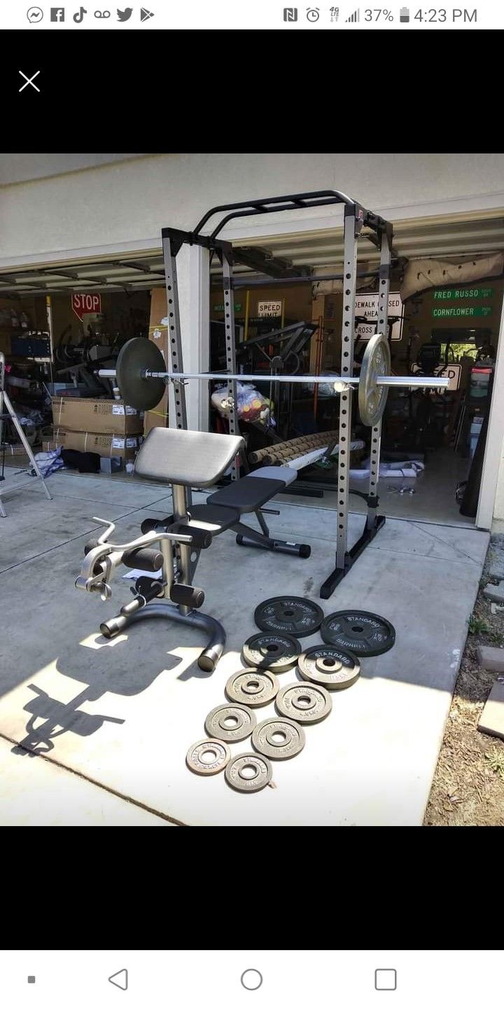 Power cage combo with 300lb Olympic weight set and Olympic curl bar