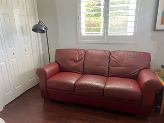 Red leather, couch with fold out bed