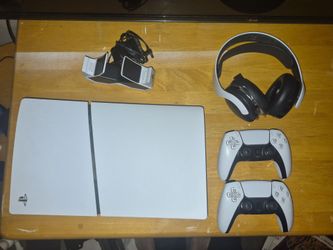 Playstation 5 w/ disc drive, 2 controllers, a charging station, and a pair of ps5 headphones