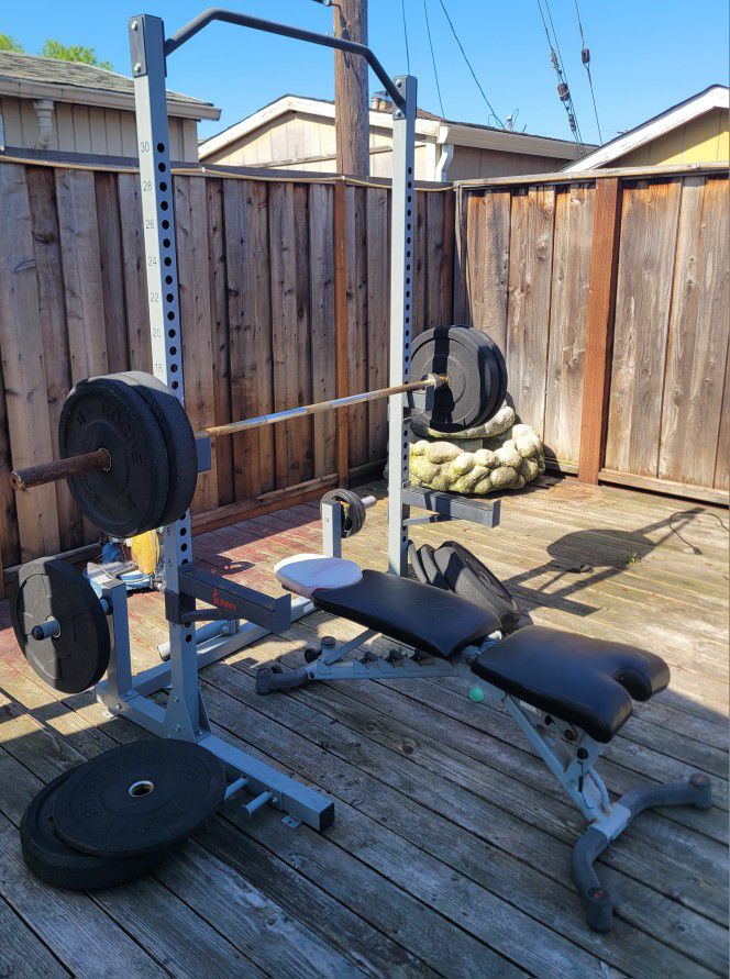 older used weight rack, bench and weights.