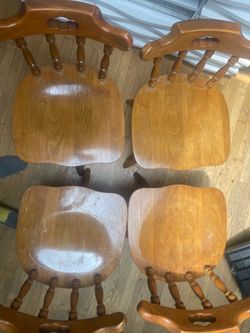 4 wooden swivel chairs