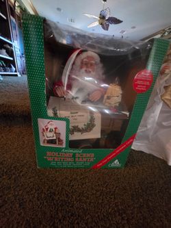 Animated santa claus, christmas plug it in and he moves writing on the desk and plays music