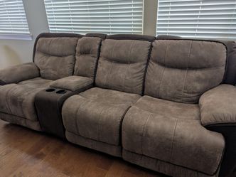 Brown leather all reclining couch and reclining rocking chair