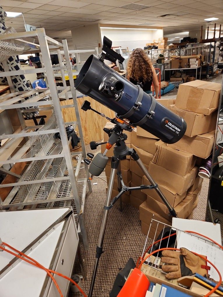 Celestron Astromaster 130 telescope with stand.