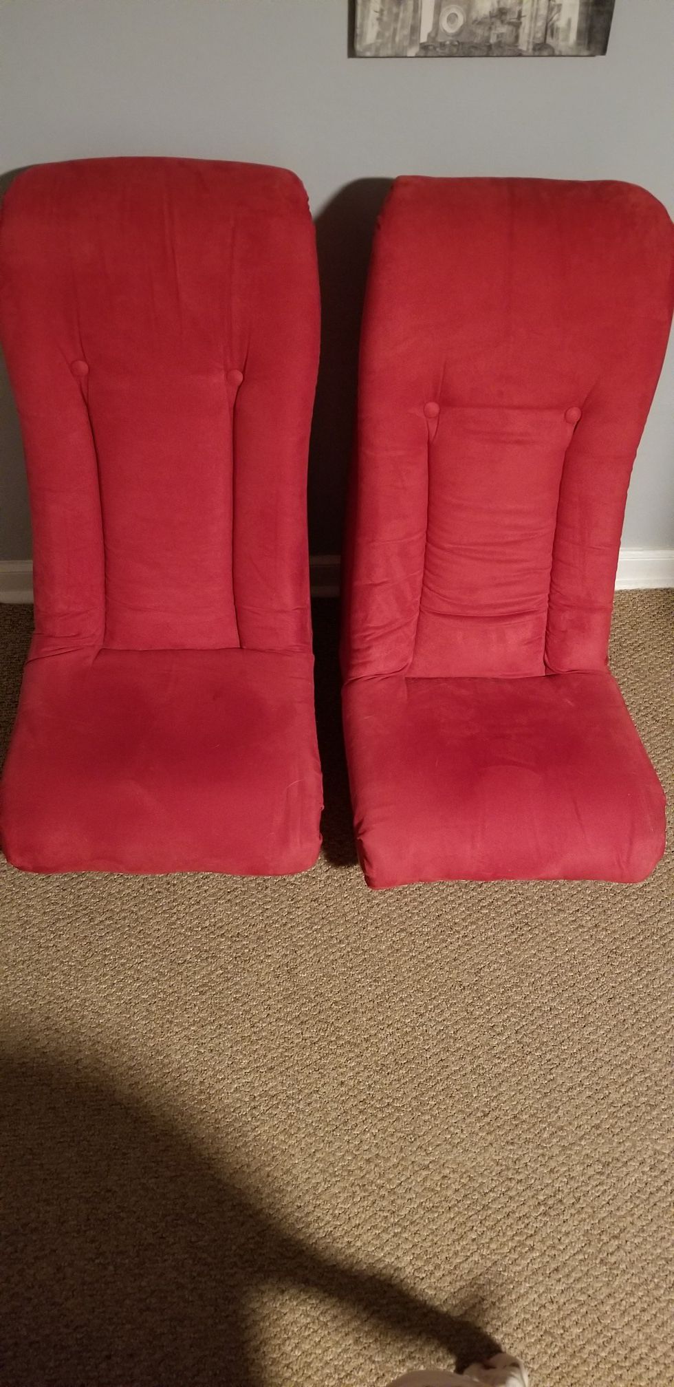 Two red rocker gaming chairs
