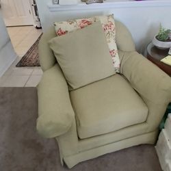 This is 2 skirted English club armchairs in a light green color.