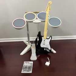 Nintendo Wii Rock band ( wired drums, guitar, dongel, sticks, pedal and game)