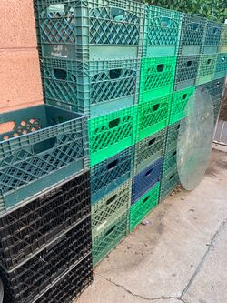 A Bunch of Green Plastic and black with silver rim Milk Crates